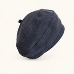 Woman wearing navy cotton linen French beret