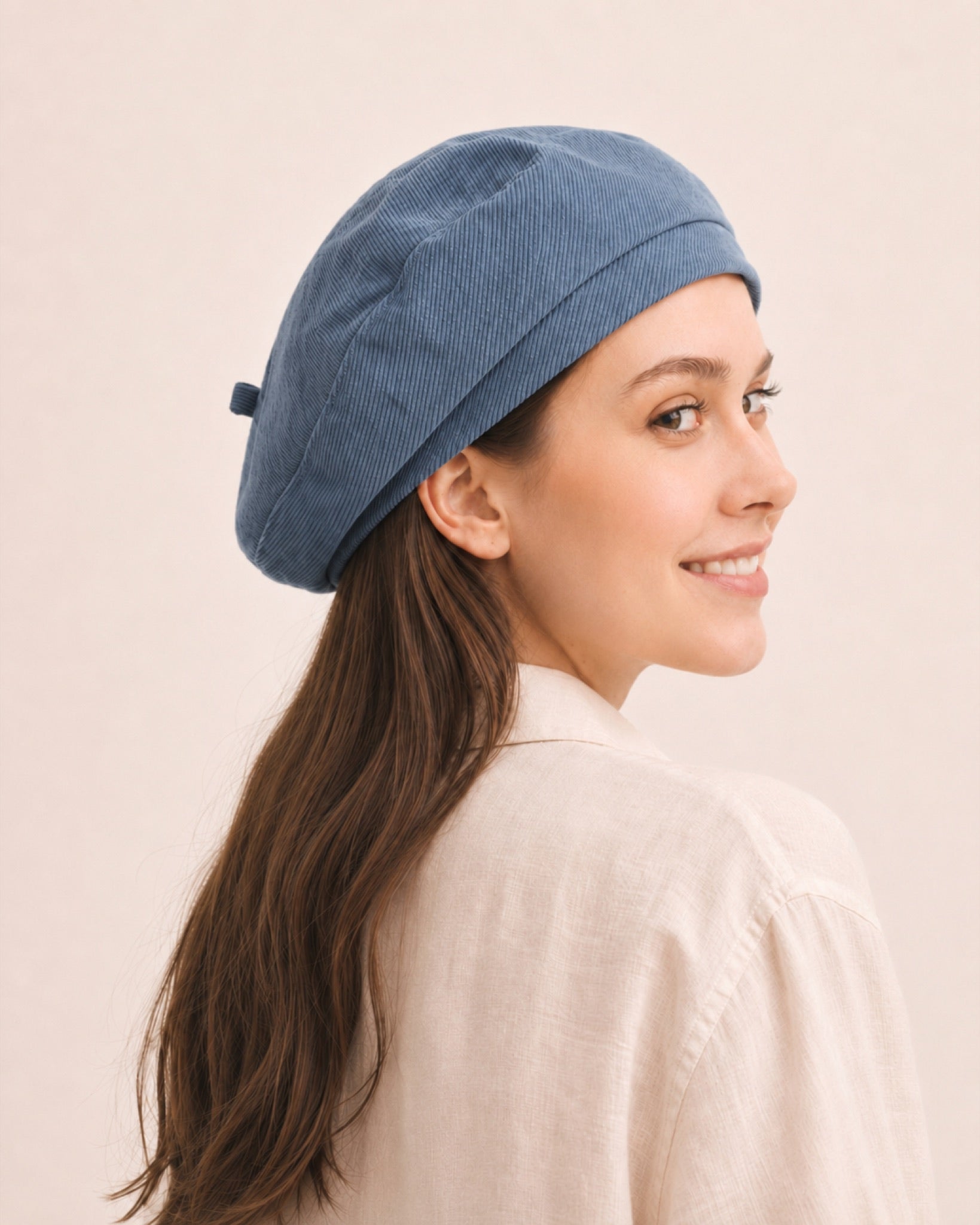 Woman wearing blue cotton linen French beret