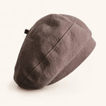 Woman wearing taupe cotton linen French beret