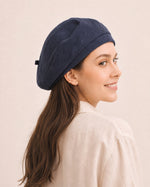 Woman wearing navy cotton linen French beret