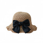 Women's camel straw beach hat with black bow, side view, white background