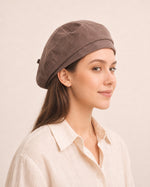 Woman wearing taupe cotton linen French beret