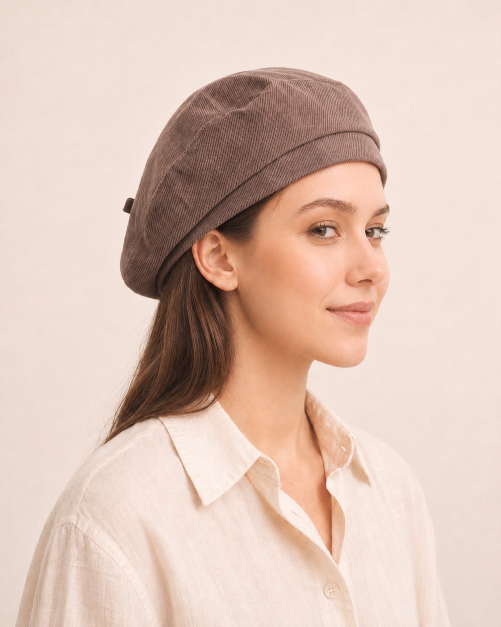 Woman wearing taupe cotton linen French beret