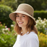 Woman wearing Straw Bucket Hat with Linen Band, three-quarter view in garden