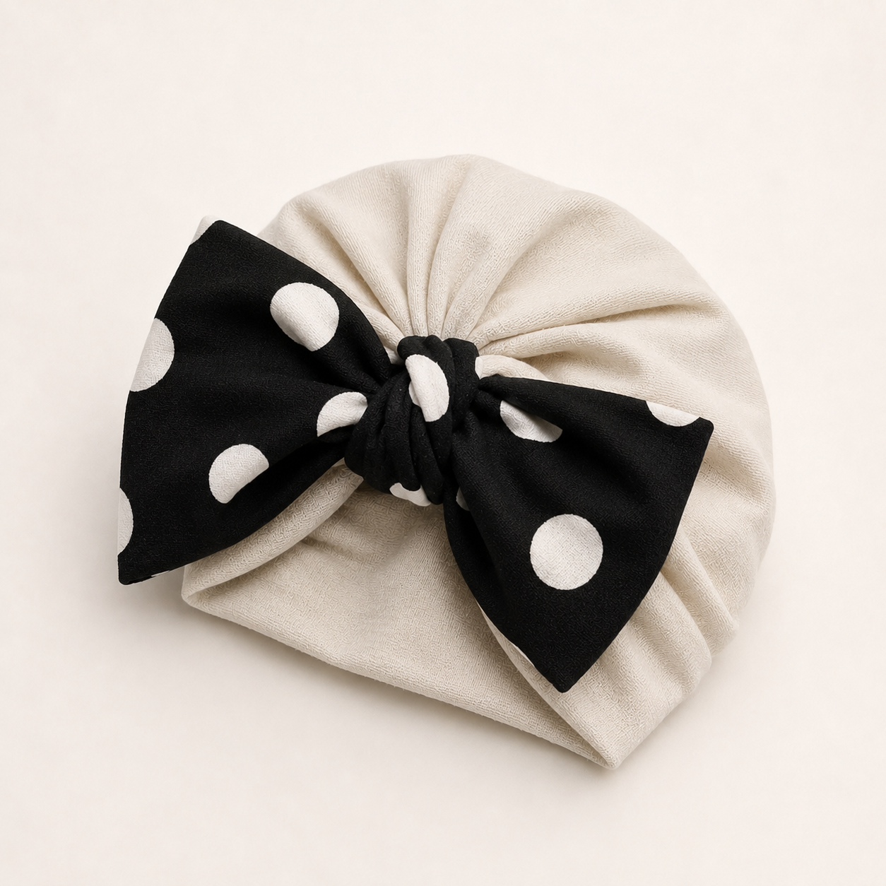 Beige modal cotton turban hair wrap with a black polka dot bow