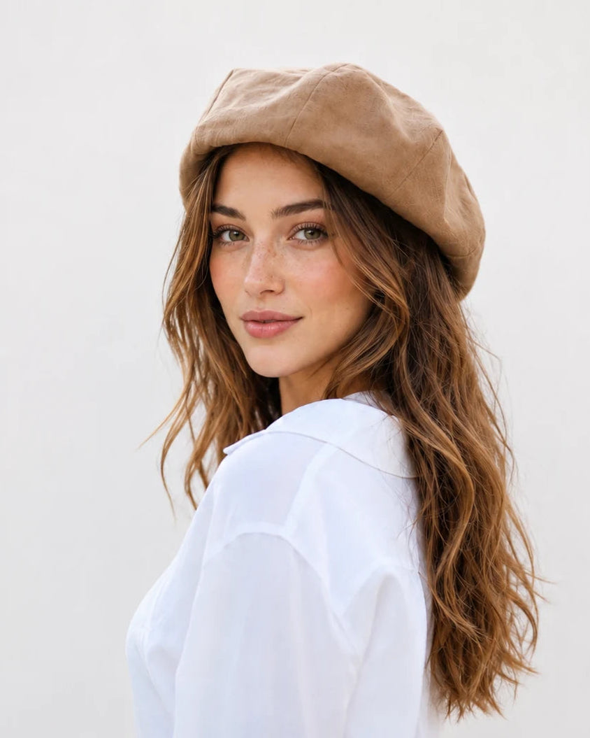 Woman wearing camel linen French beret, side view