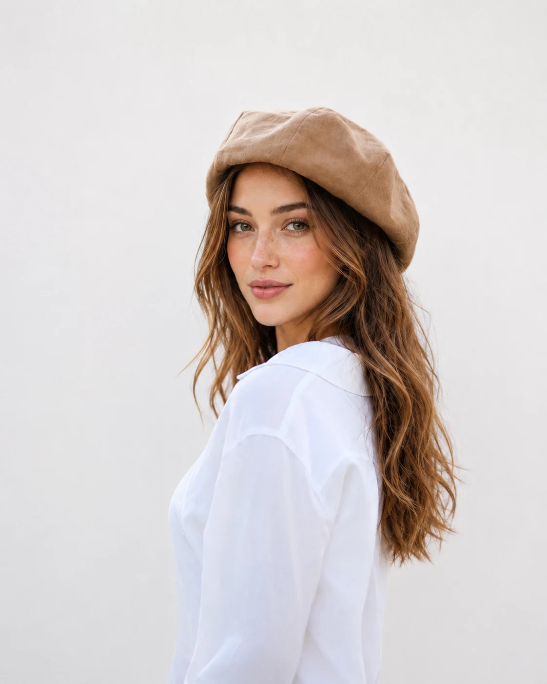 Woman wearing camel linen French beret, side view