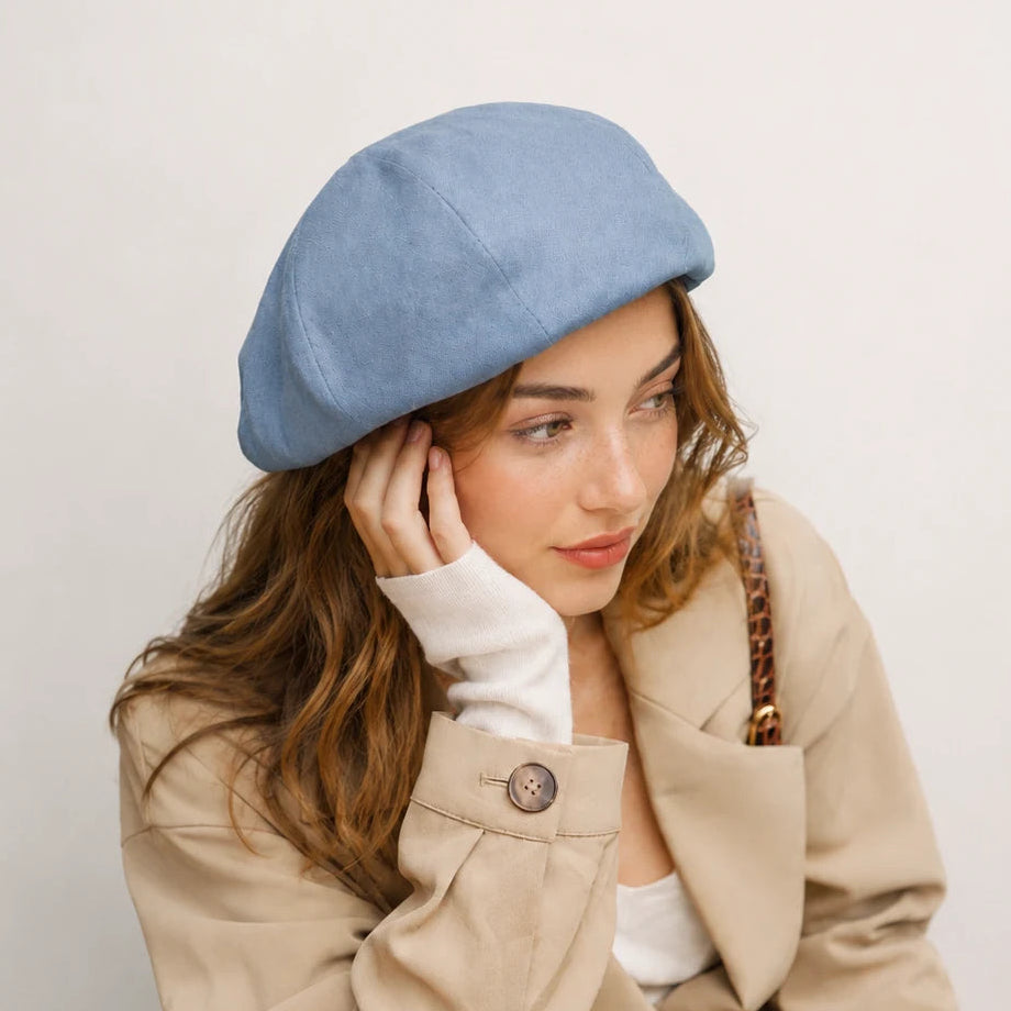 Woman wearing light blue linen-cotton blend French beret
