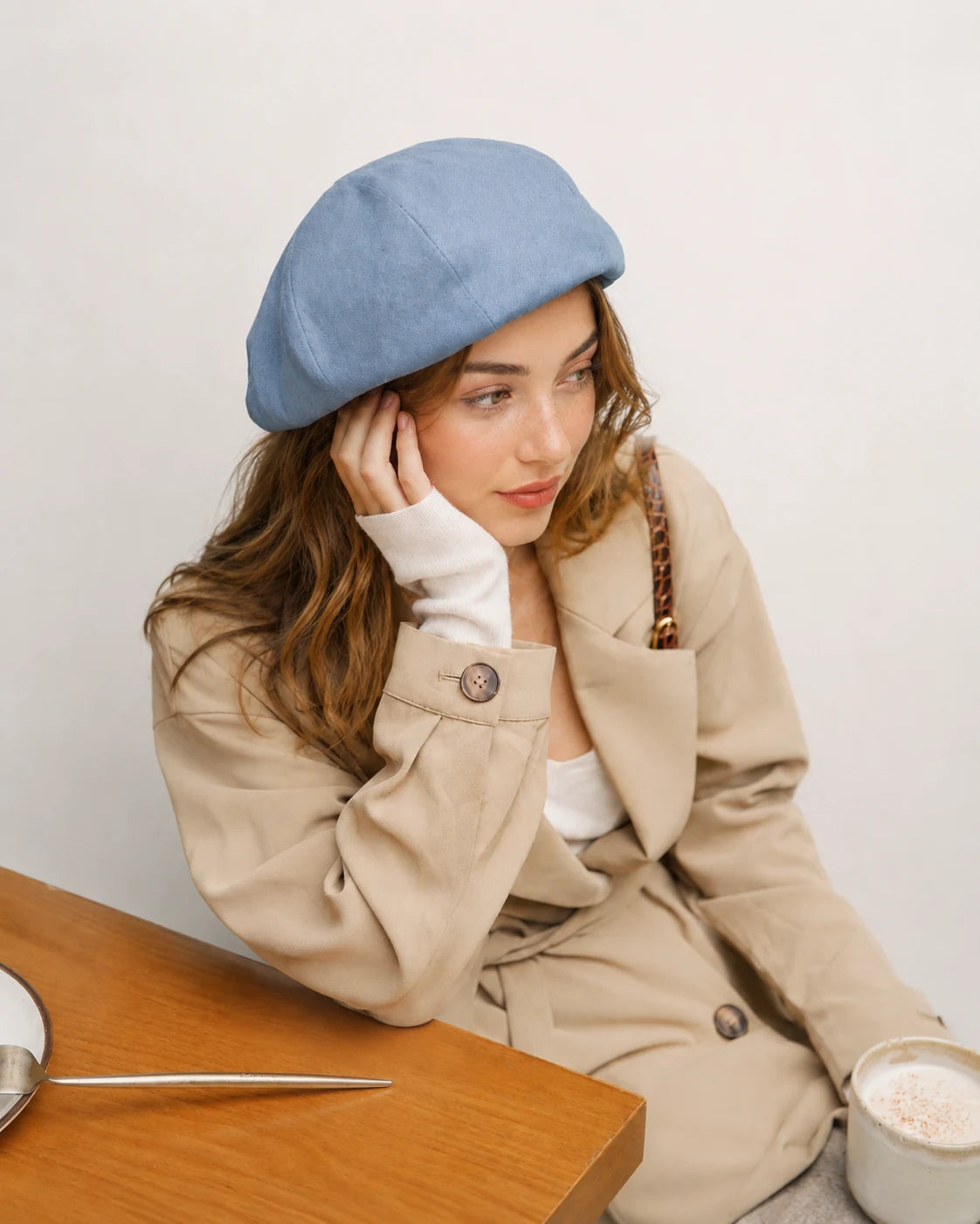 Woman wearing light blue linen-cotton blend French beret
