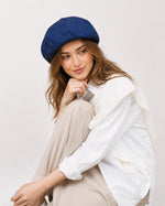 Woman wearing navy linen French beret