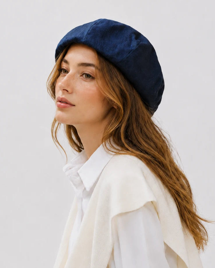 Woman wearing navy linen French beret