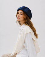 Woman wearing navy linen French beret
