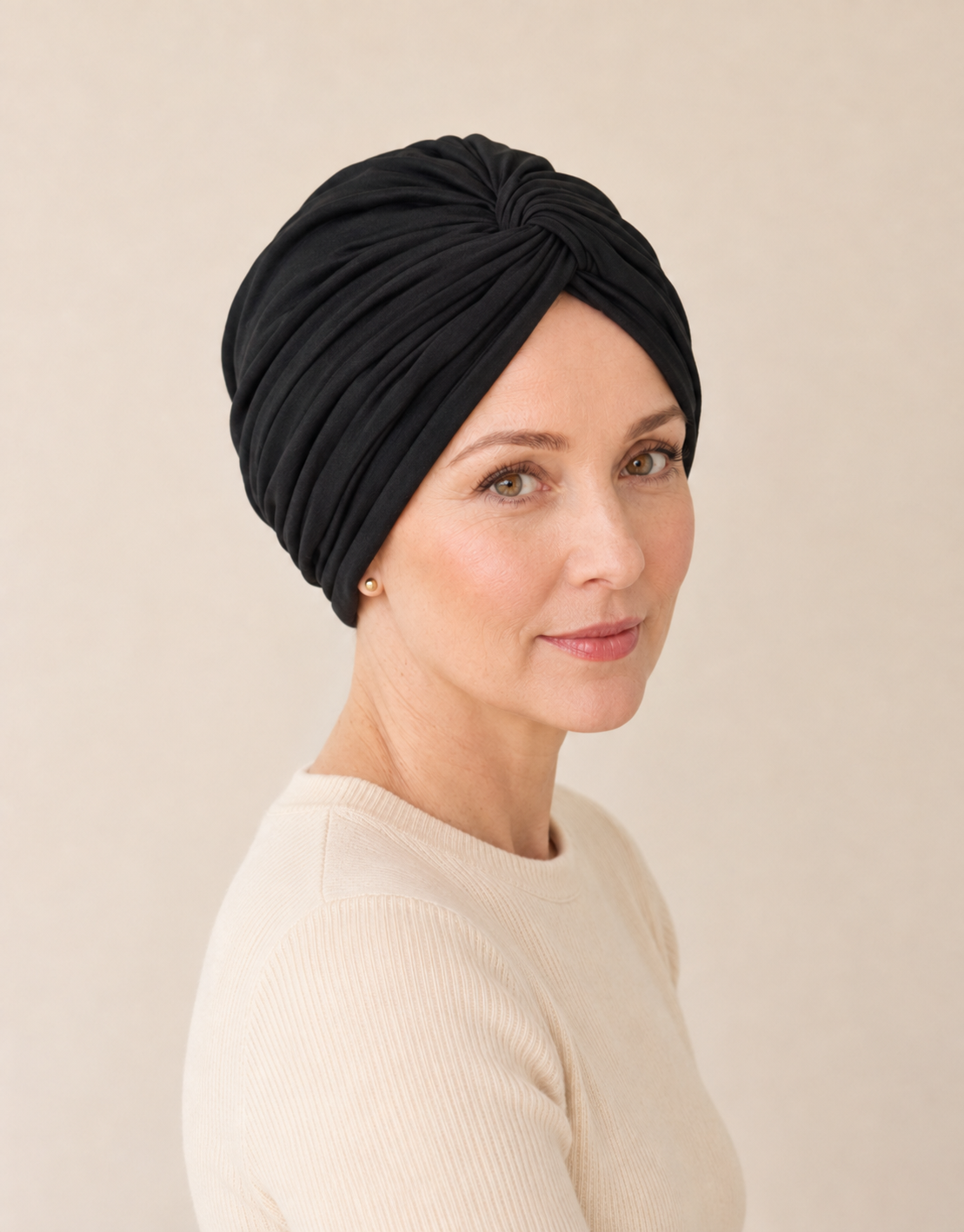 Woman wearing a black chemo-friendly modal cotton knot turban head wrap