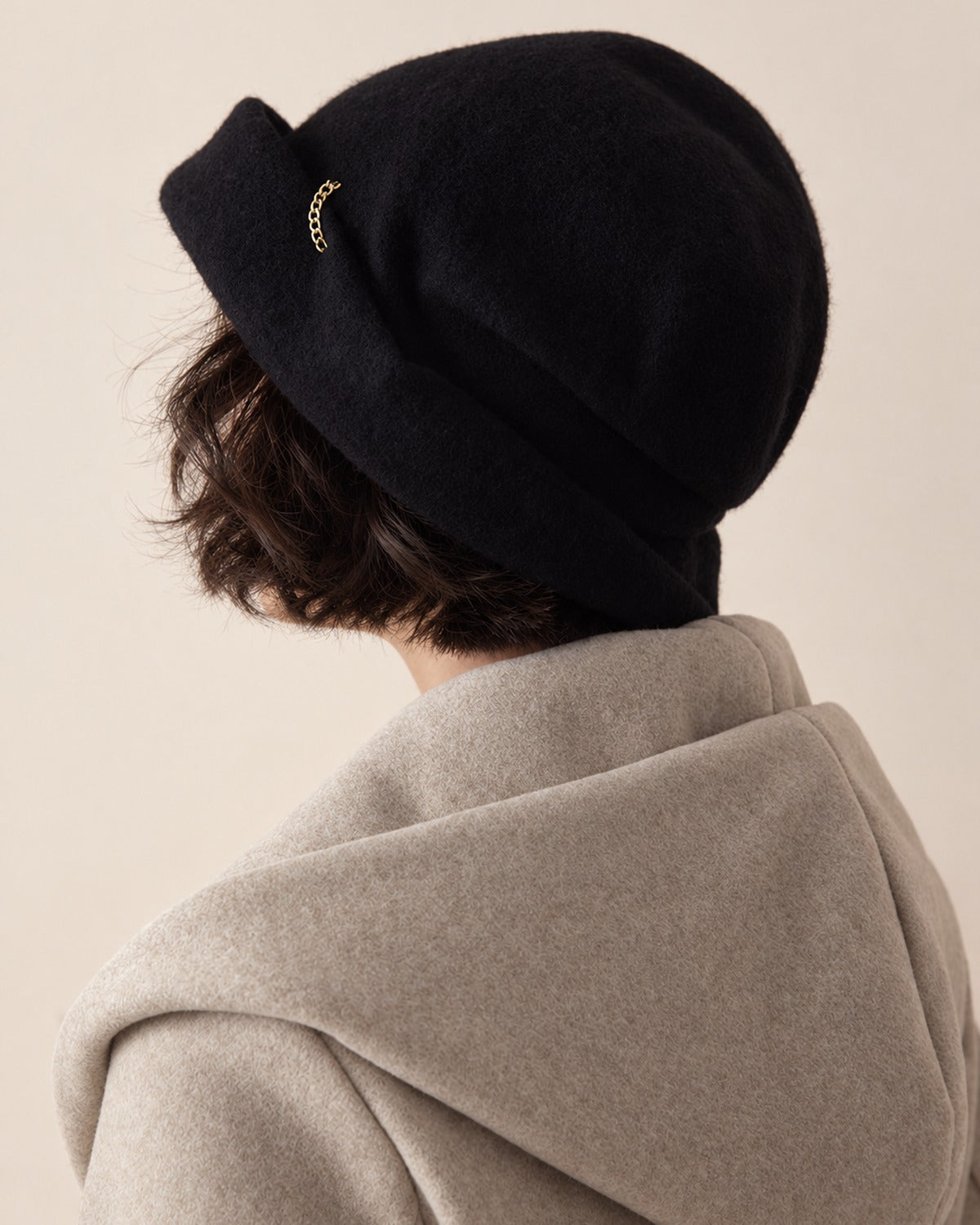 Classic Black wool slouchy beret shown from a rear three-quarter view on a white female model