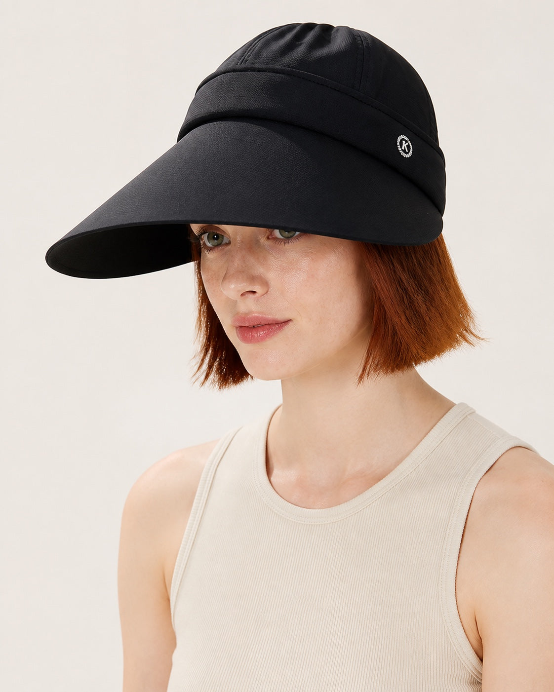 Black 2-in-1 wide brim sun hat with removable top for women, shown on a studio model