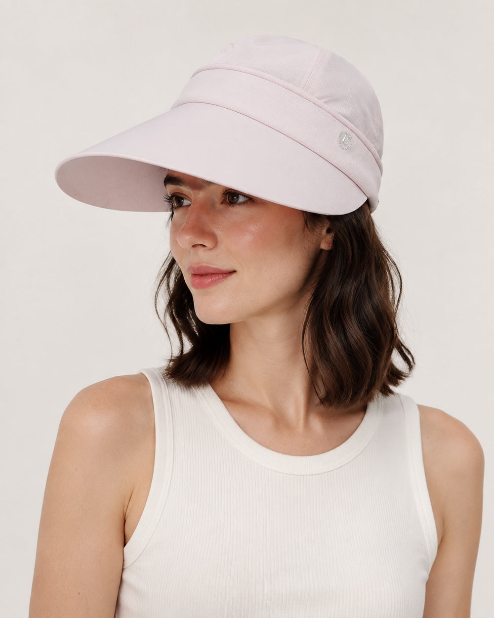 Pink 2-in-1 wide brim sun hat with removable top for women, shown on a studio model