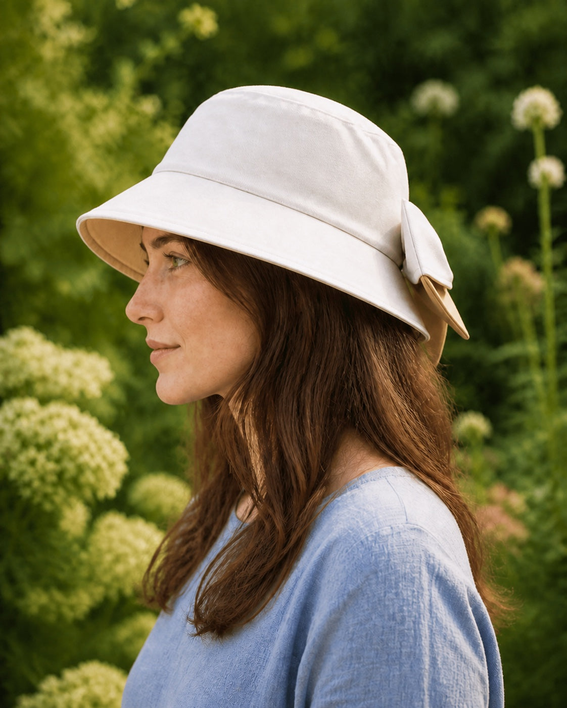 Woman wearing a beige bucket hat with camel lining – side profile