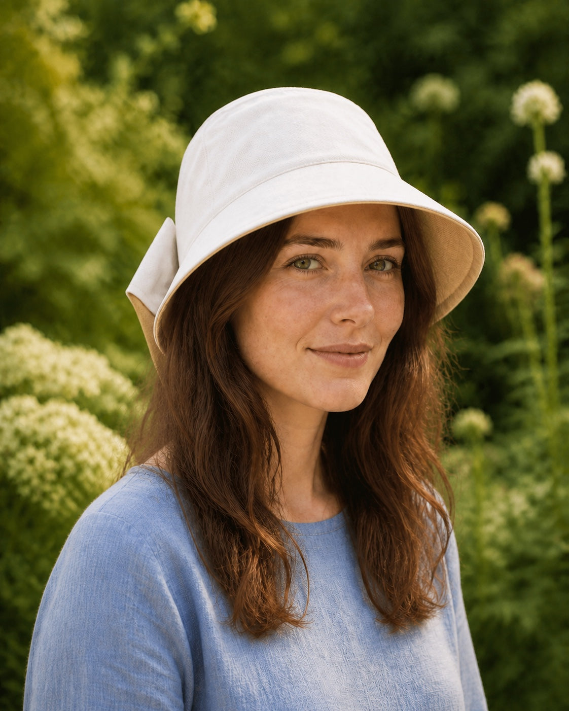 Woman wearing a beige bucket hat with camel lining – three-quarter view