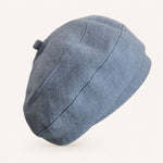 Woman wearing blue cotton linen French beret