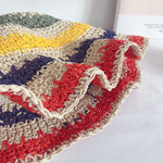 Rainbow straw hat close-up detail showing colourful crochet weave texture
