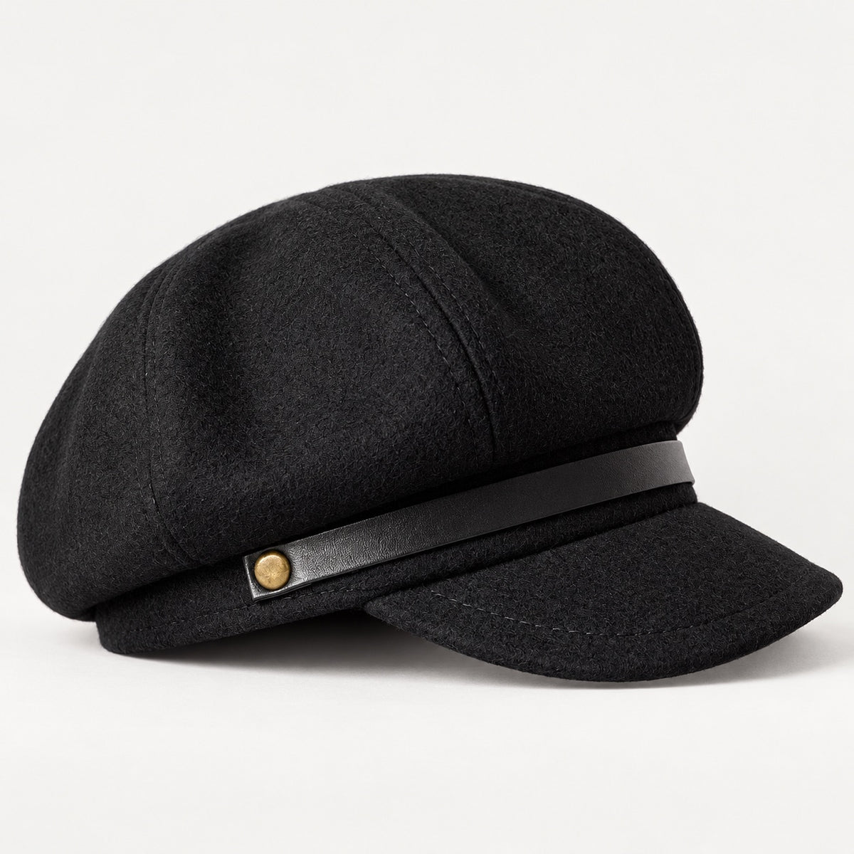 Black newsboy cap side detail showing curved brim and crown seam