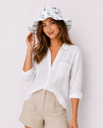 Woman wearing white feather-print bucket hat