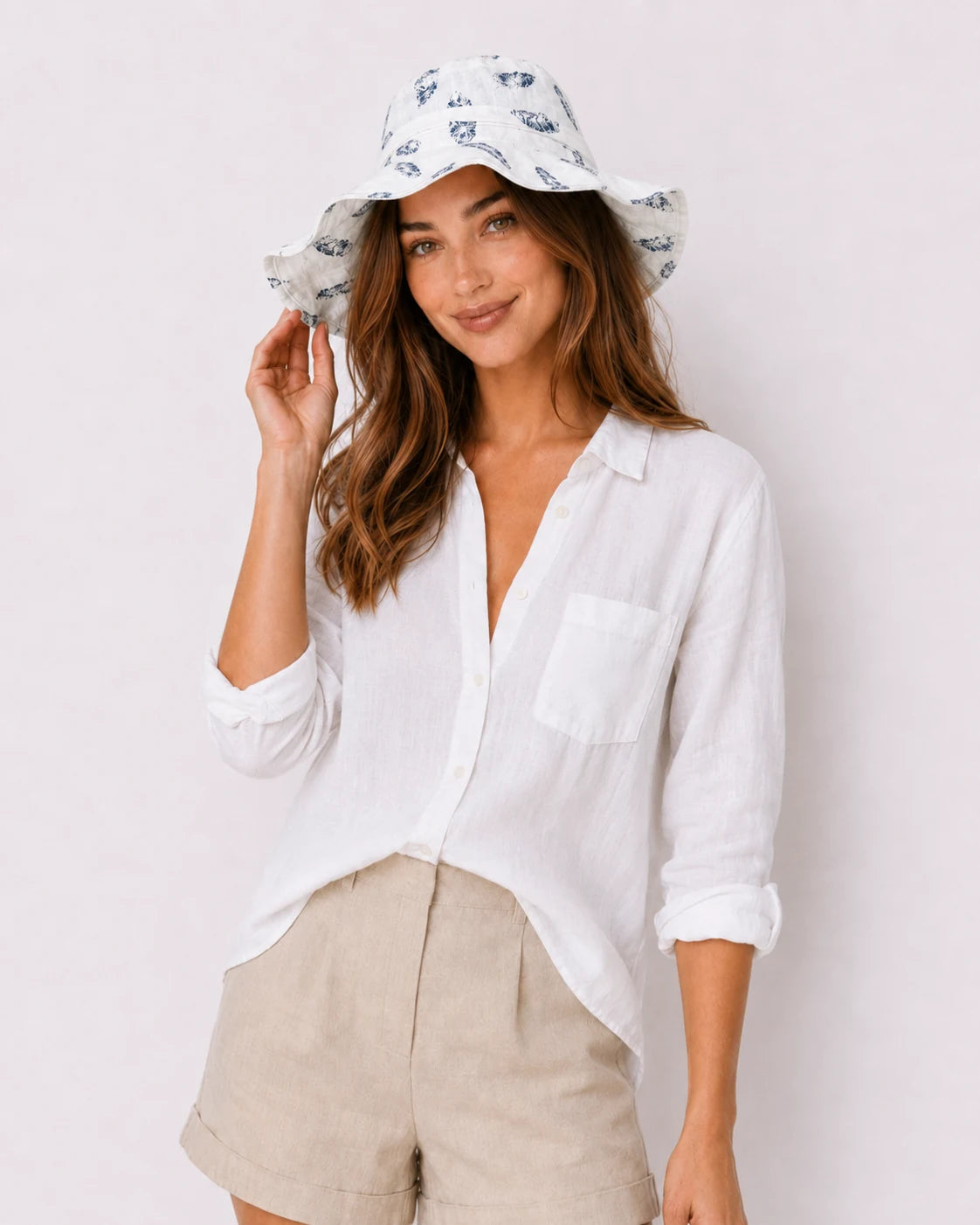 Woman wearing white feather-print bucket hat