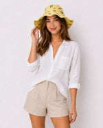 Woman wearing yellow feather-print bucket hat