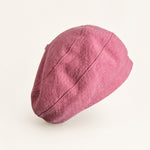Woman wearing pink cotton linen French beret