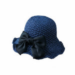 Women's blue straw sun hat with black bow, white background