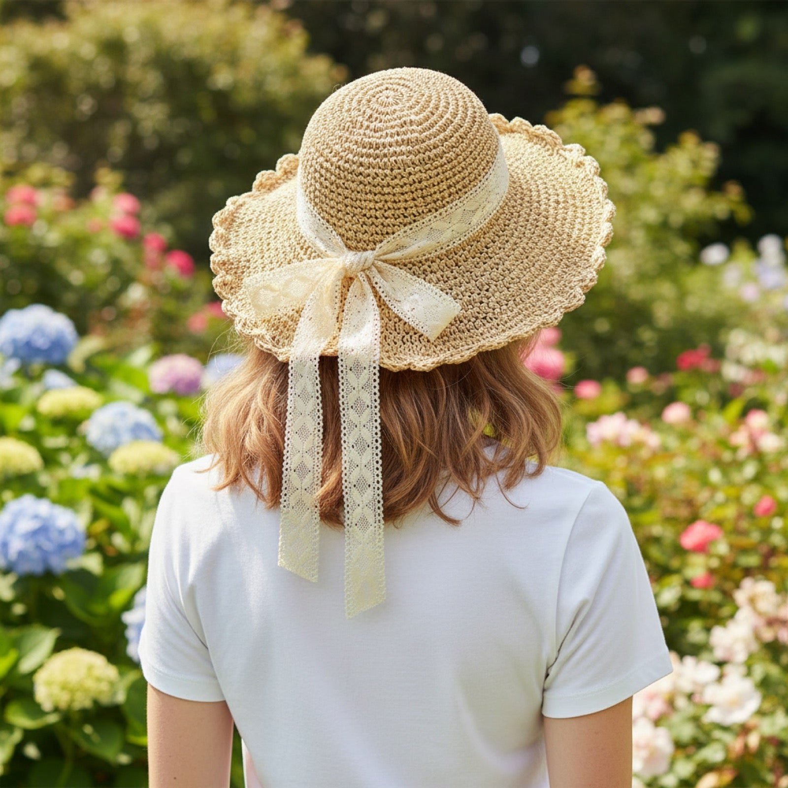 Woman wearing scalloped straw sun hat with lace bow in garden - back view showing lace ribbon