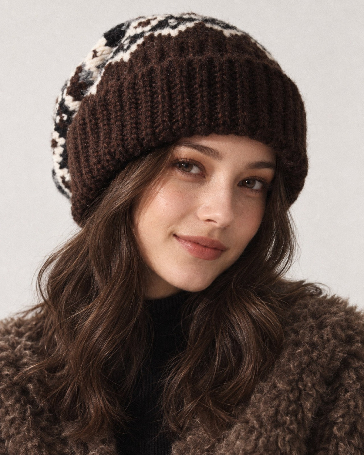 Young woman wearing the Coffee Fair Isle oversized slouchy beanie, front studio portrait