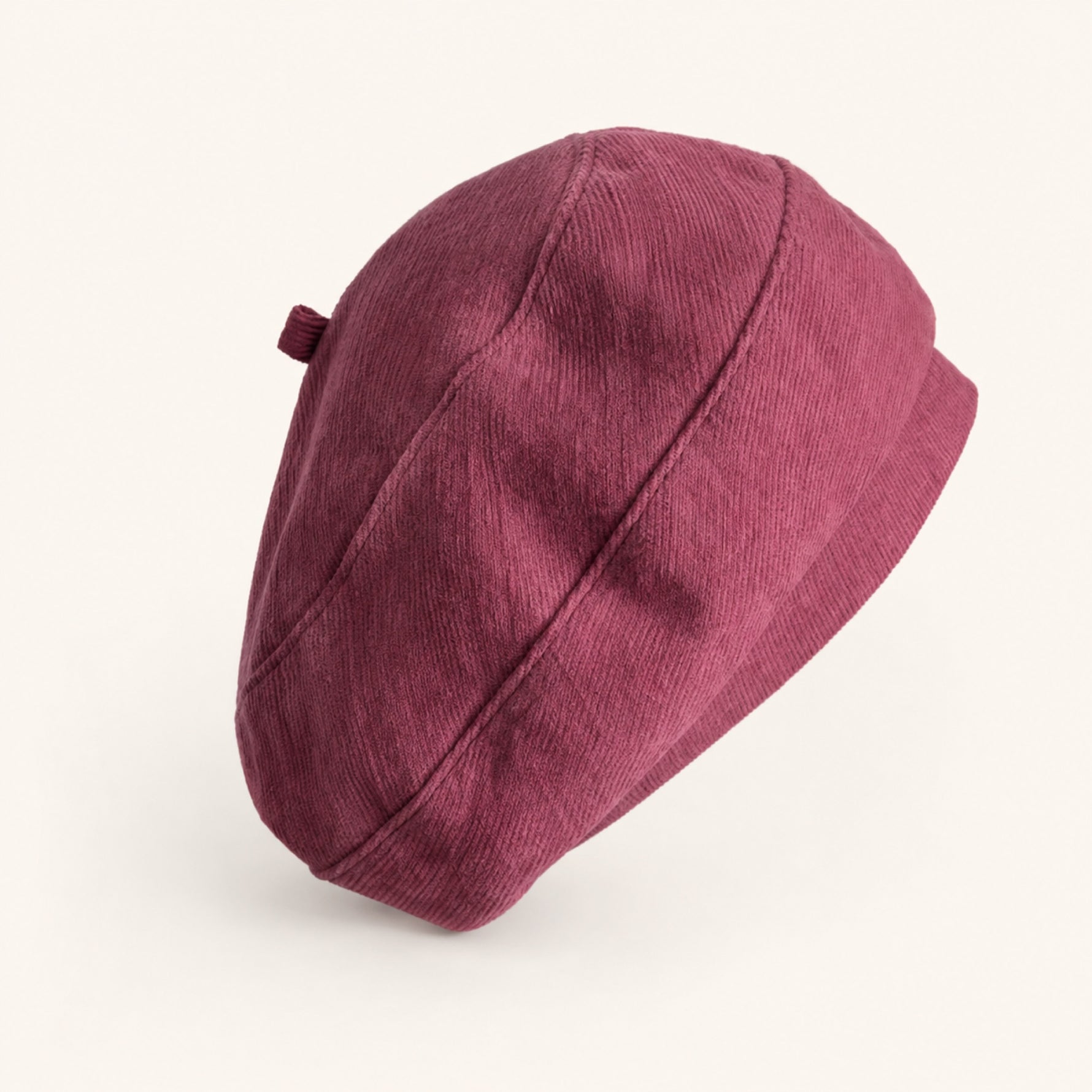 Woman wearing dark pink cotton linen French beret