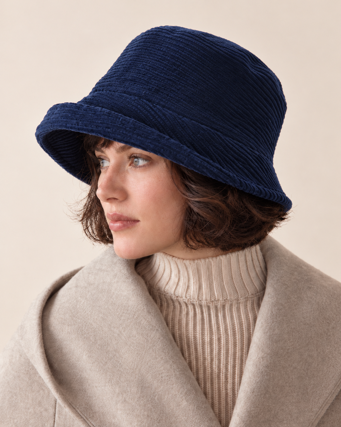 navy corduroy asymmetric brim bucket hat without metal badge on short-haired female model