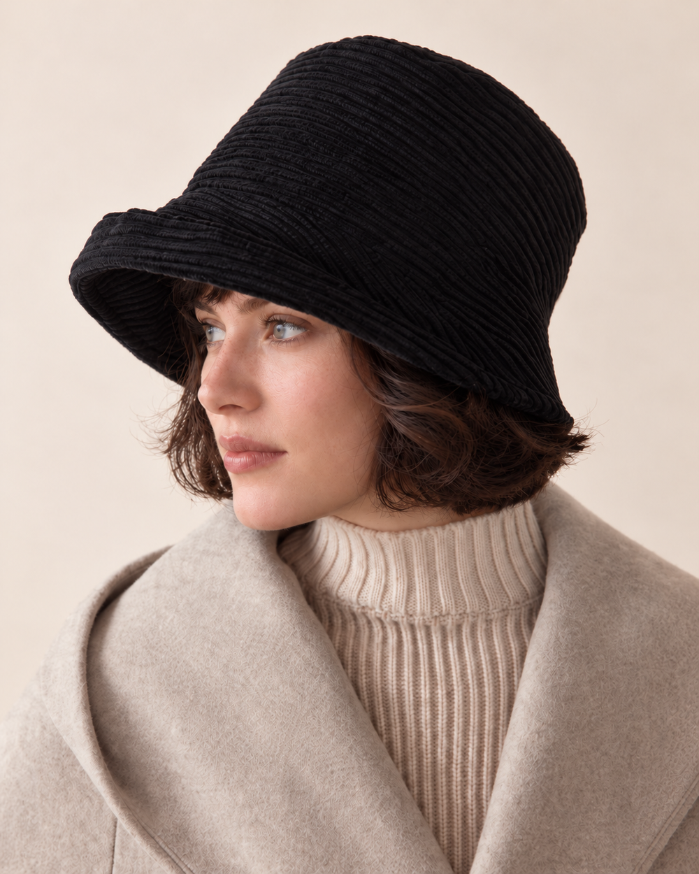 black corduroy asymmetric brim bucket hat without metal badge on short-haired female model