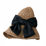 Two camel straw hats with black bow, flat lay view, white background