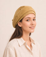 Woman wearing yellow cotton linen French beret