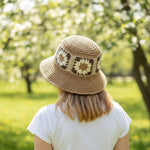 Woman wearing Flower Decorated Straw Bucket Hat back view