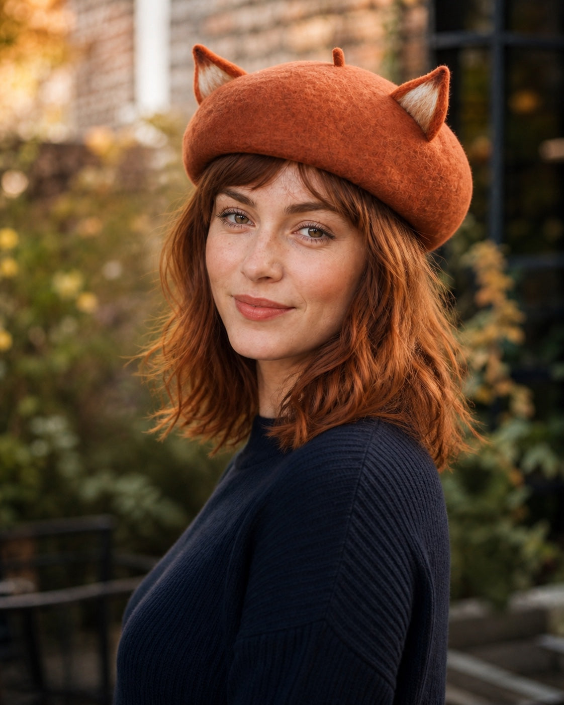 White model wearing the rust-brown wool fox-ear French beret at a left-front 45-degree angle