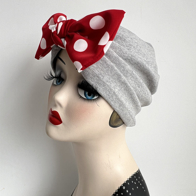 Grey modal cotton turban hair wrap with a red polka dot bow on mannequin