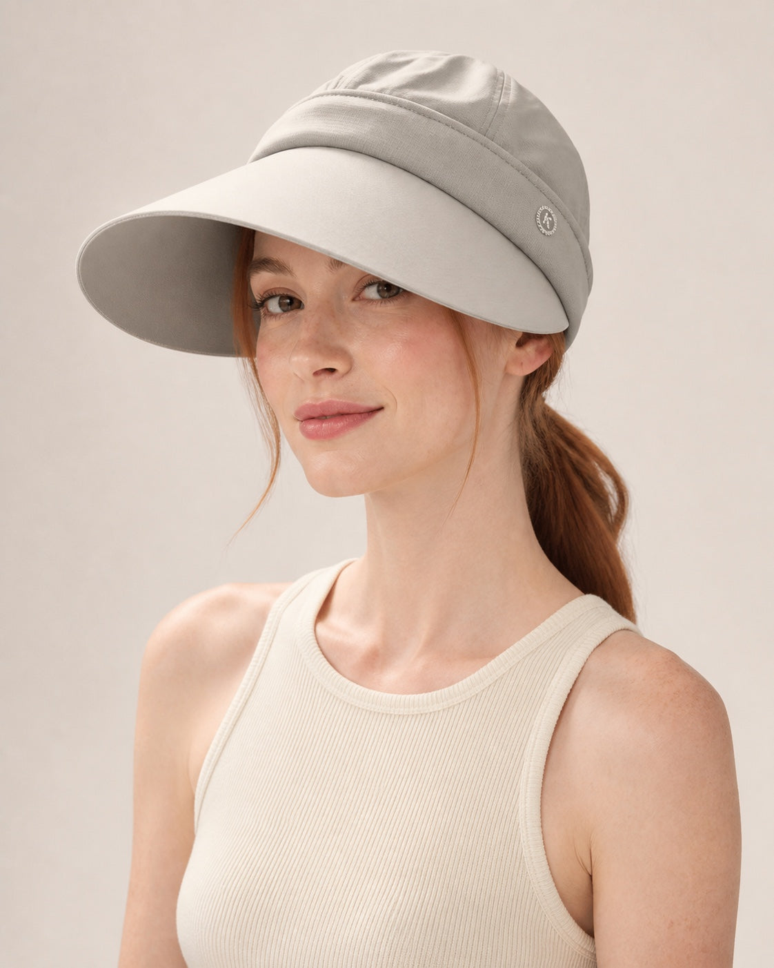 Beige 2-in-1 wide brim sun hat with removable top for women, shown on a studio model