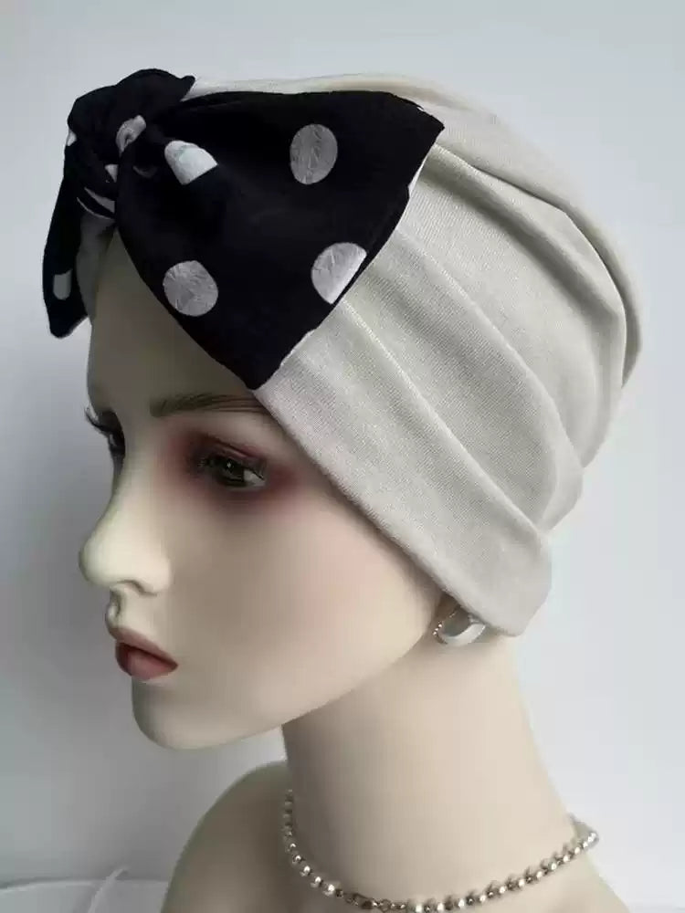 Khaki modal cotton turban hair wrap with black polka dot bow, side view