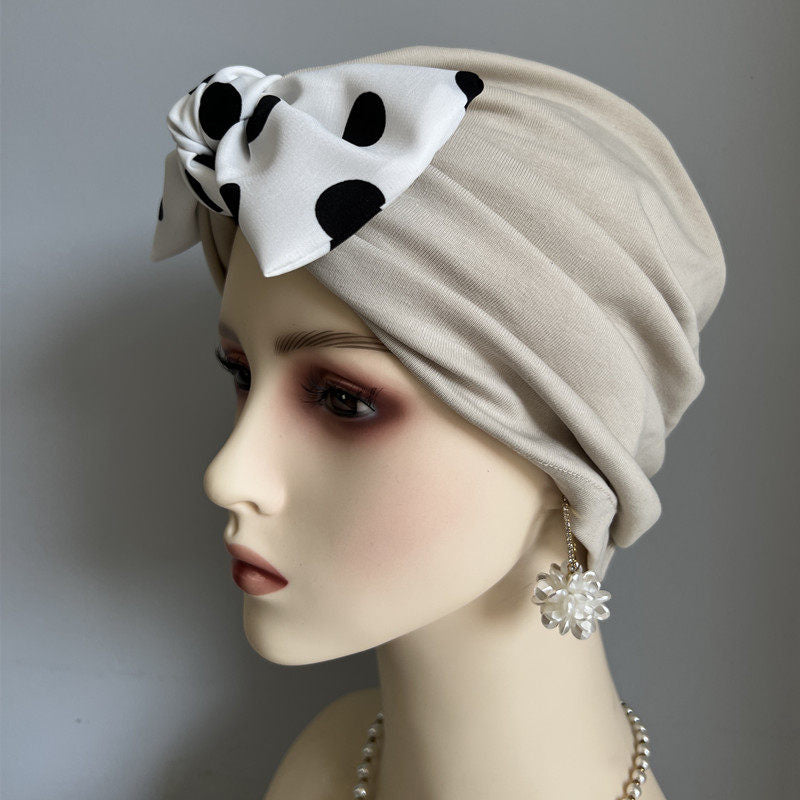 Khaki modal cotton turban hair wrap with white polka dot bow on mannequin
