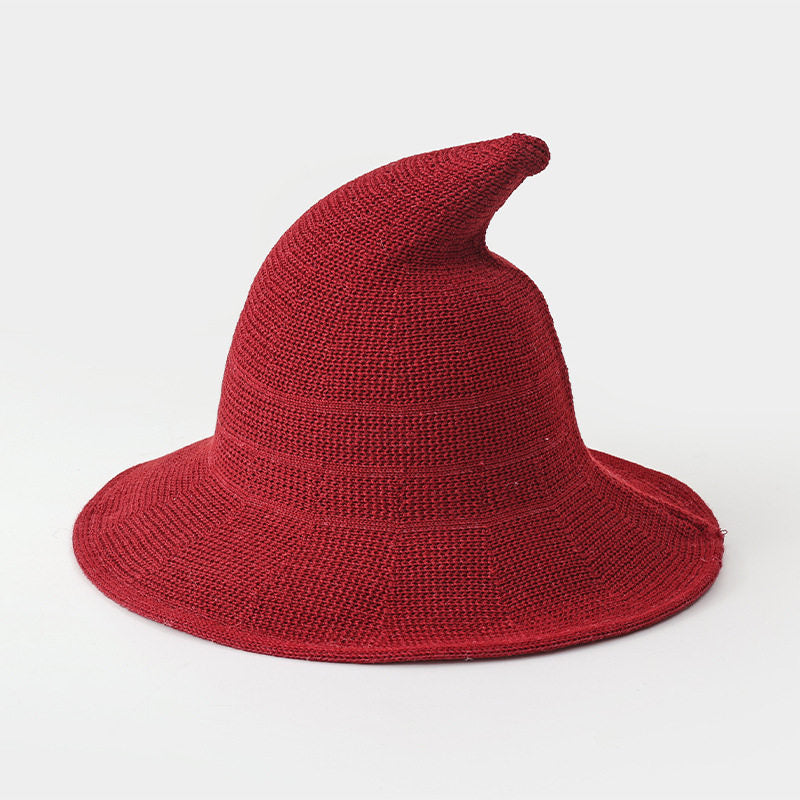 Burgundy knitted witch hat for kids on a white background