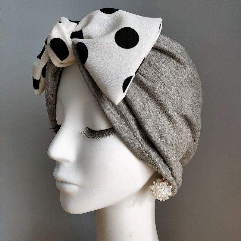 Light grey modal cotton turban hair wrap with white polka dot bow on mannequin
