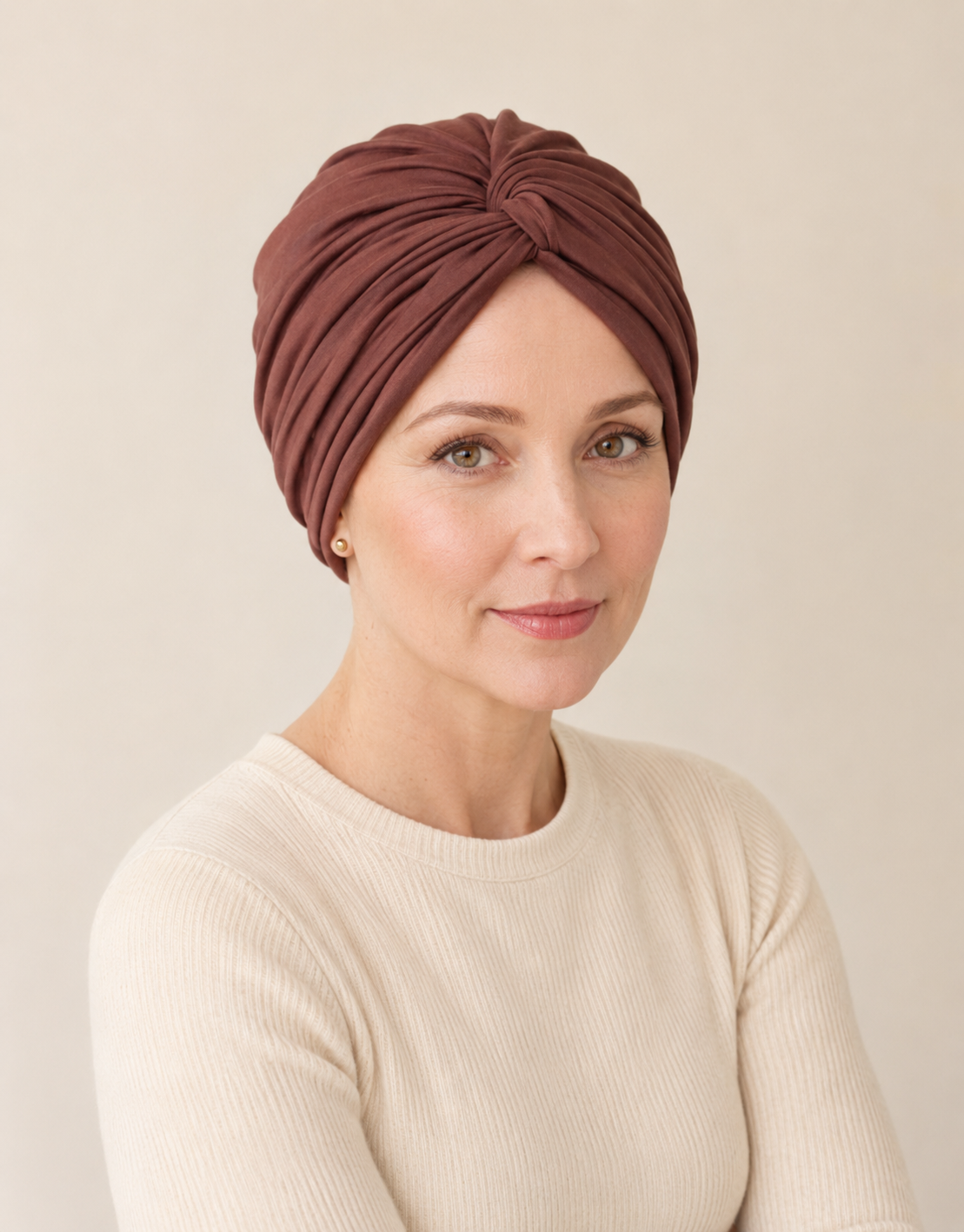 Woman wearing a mahogany chemo-friendly modal cotton knot turban head wrap