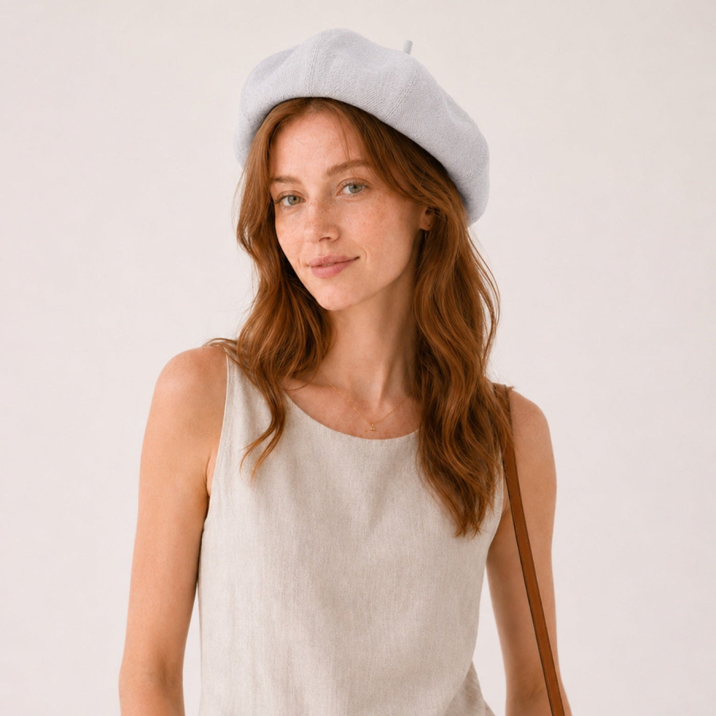 Woman wearing gray linen beret front view