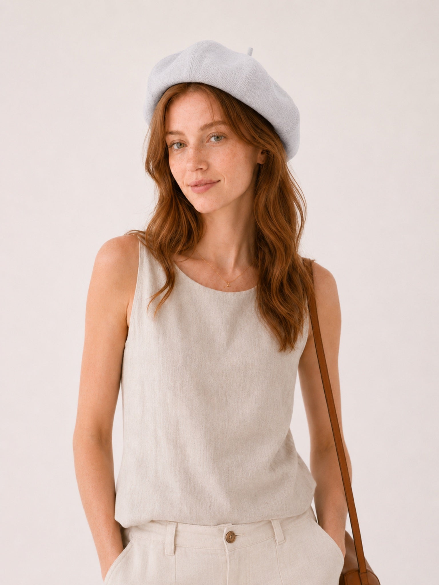 Woman wearing gray linen beret front view