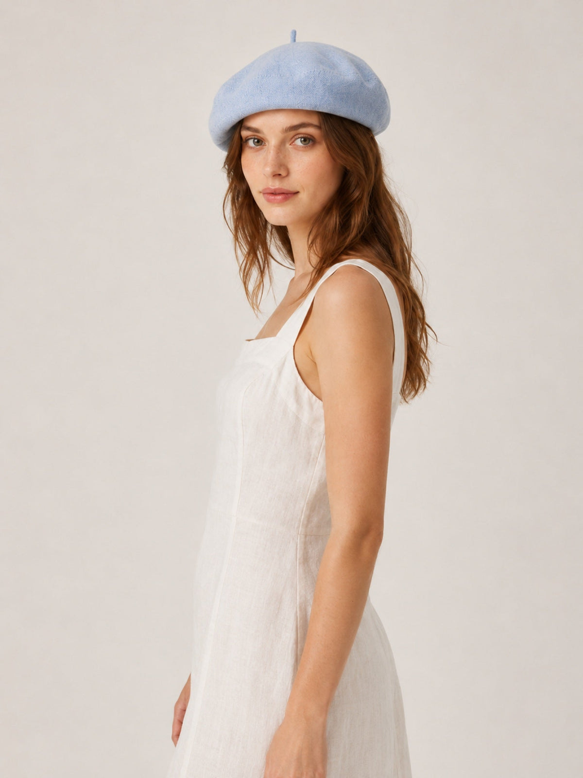 Woman wearing oversized linen French beret – Mustard