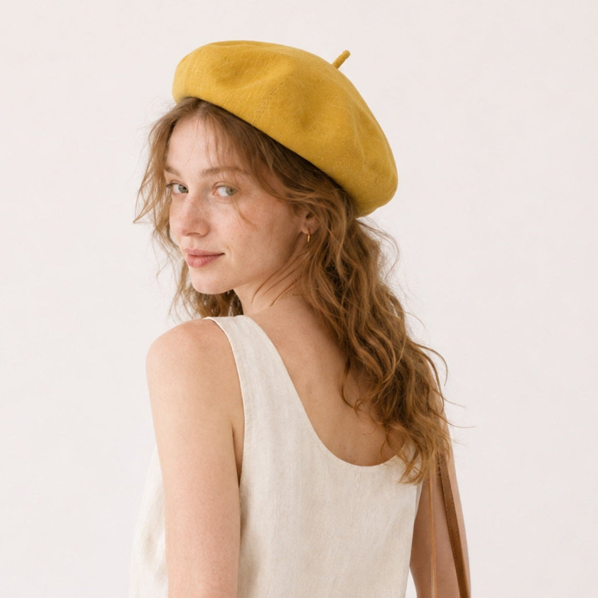 Woman wearing mustard linen beret